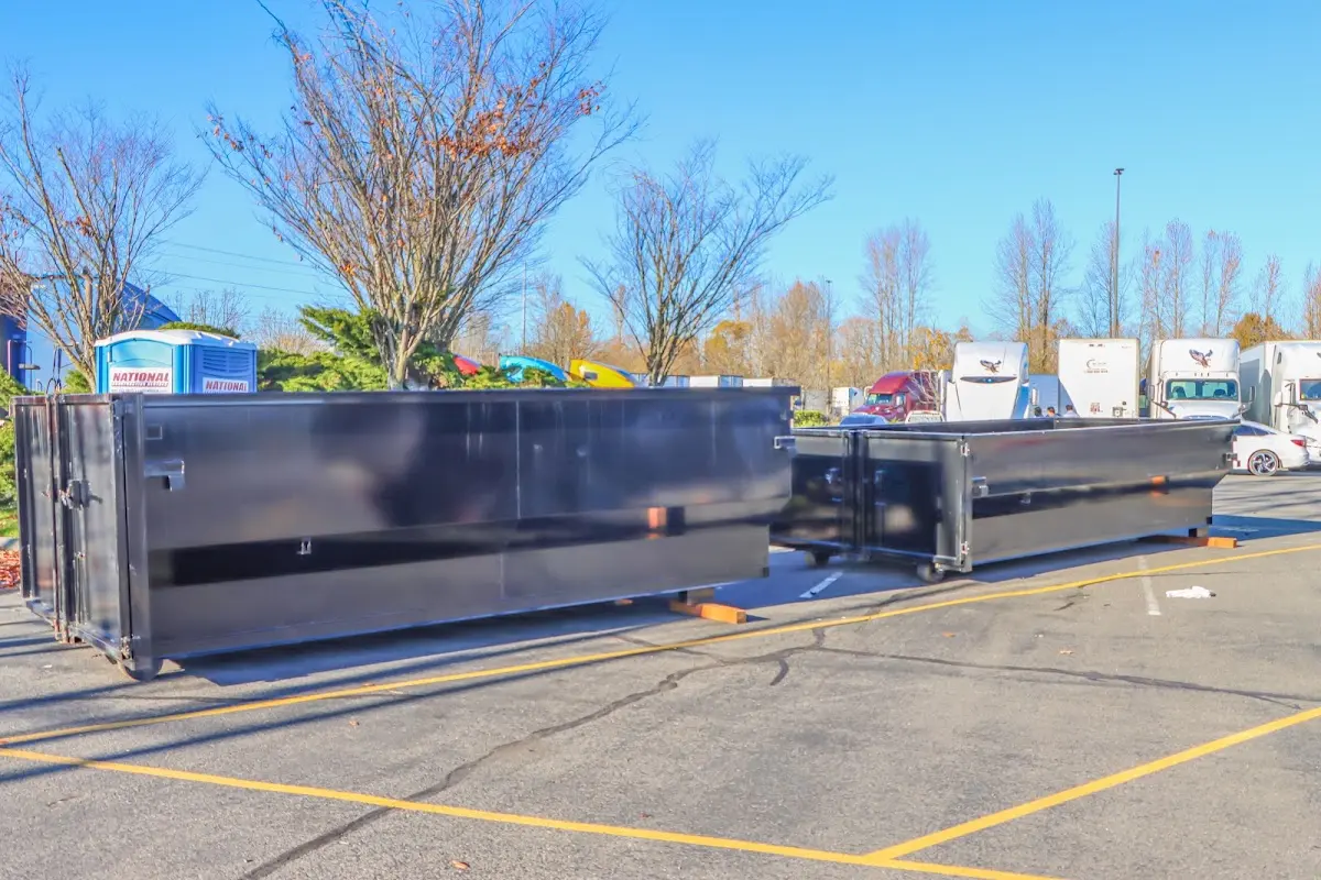 Professional dumpster rental service with roll-off container on residential driveway in Crest Hill